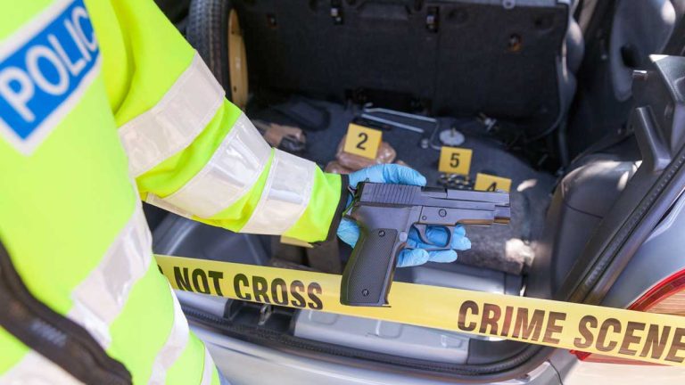 A photo depicting a gun in the trunk and a crime scene