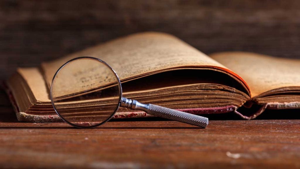 A history book and a magnifying glass