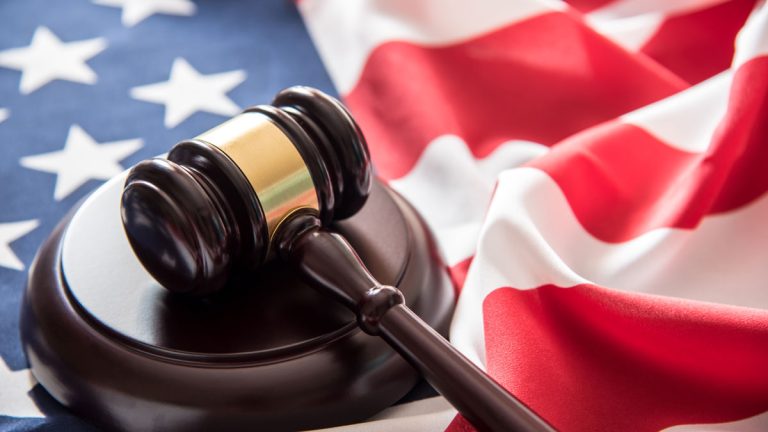 An image of a gavel and American flag