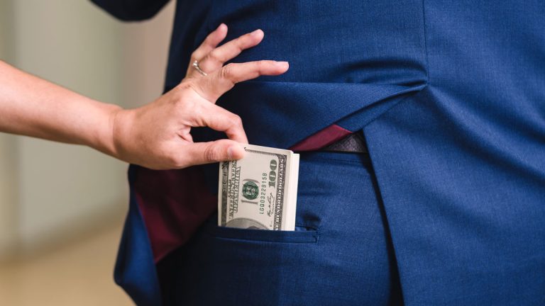 An image of a person stealing money from another person