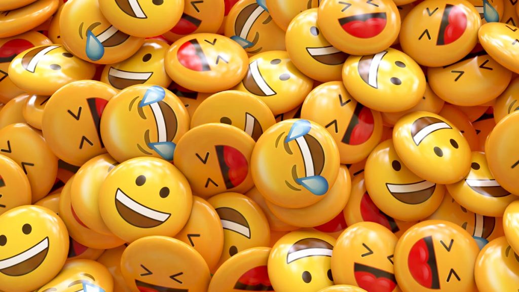 An image of a bunch of buttons with smile and laugh emojis on it.