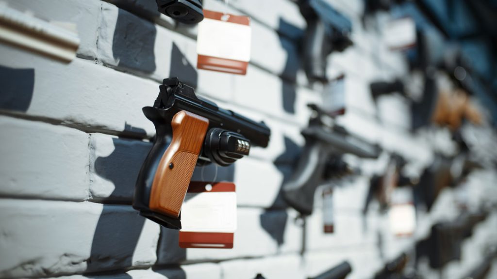 Handguns for sale on display in a gun shop.