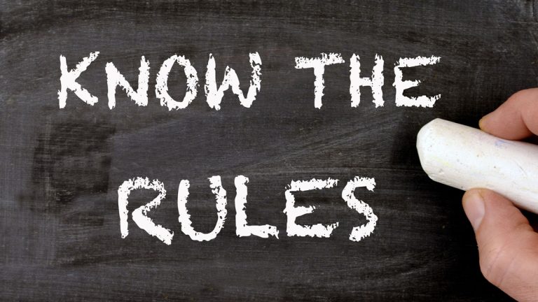 A chalkboard with the words 'know the rules'
