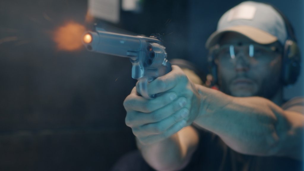 A student shooting a revolver at a shooting range