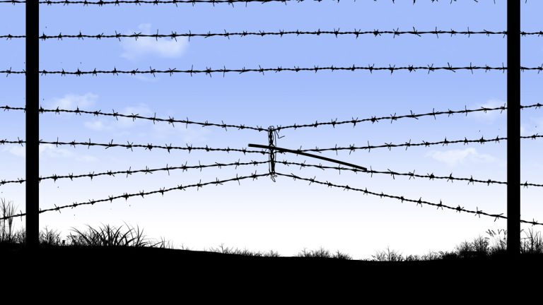 A compressed barbed wire fence at the Mexican border