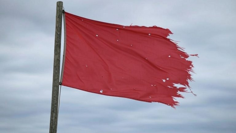 A tattered red flag
