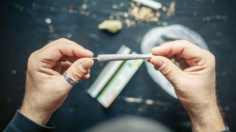 A person rolling a joint