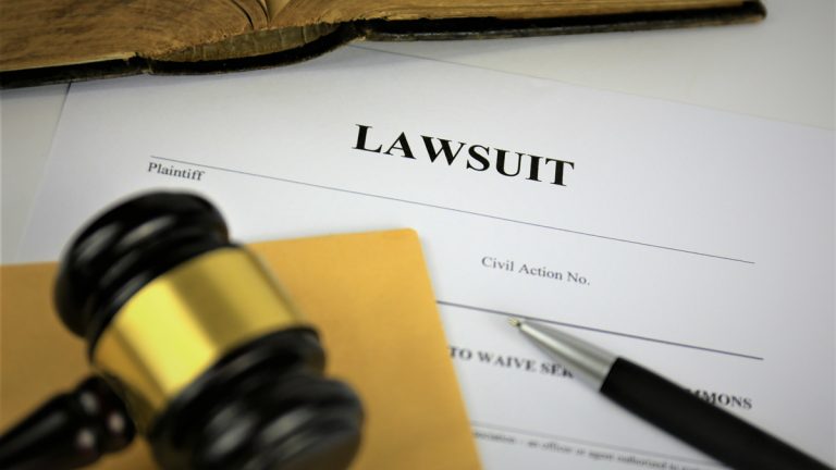 A paper that says 'lawsuit' and a gavel
