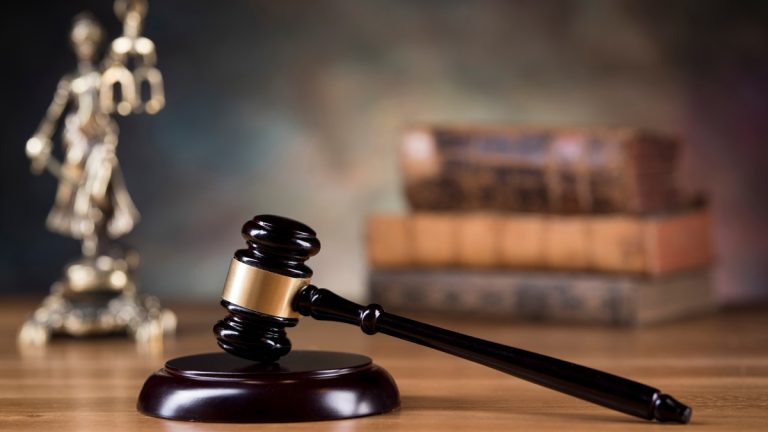 A gavel, some law books, and scales of justice