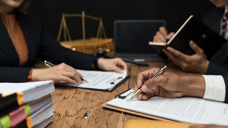 Lawyers sitting in a room writing briefs