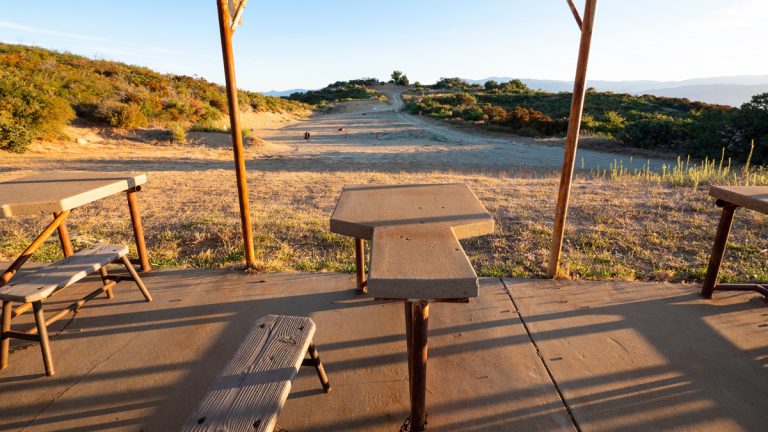 An outdoor shooting range and a rifle bench