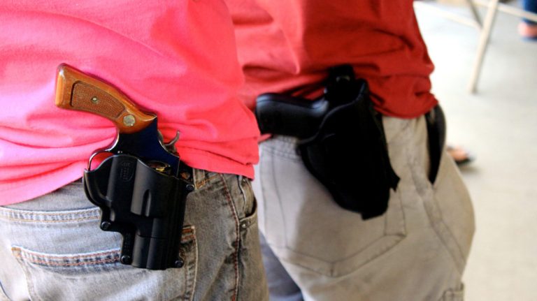 A person with an openly carried, holstered firearm.