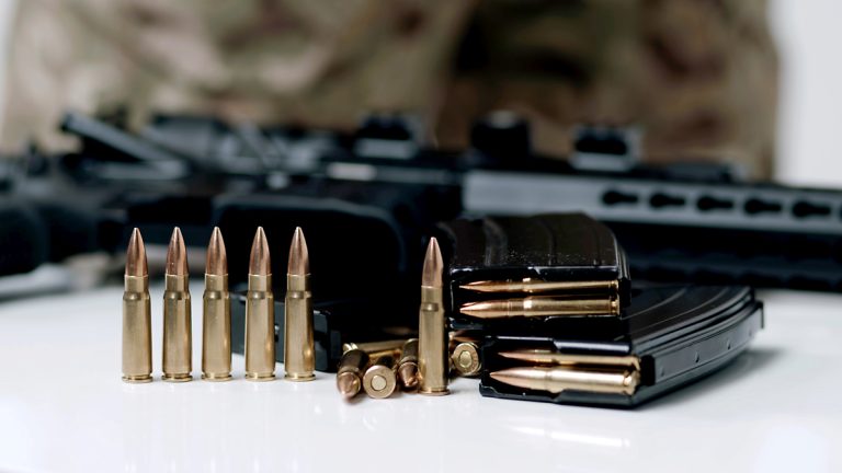 7.62 x 39 ammo and a rifle in the background