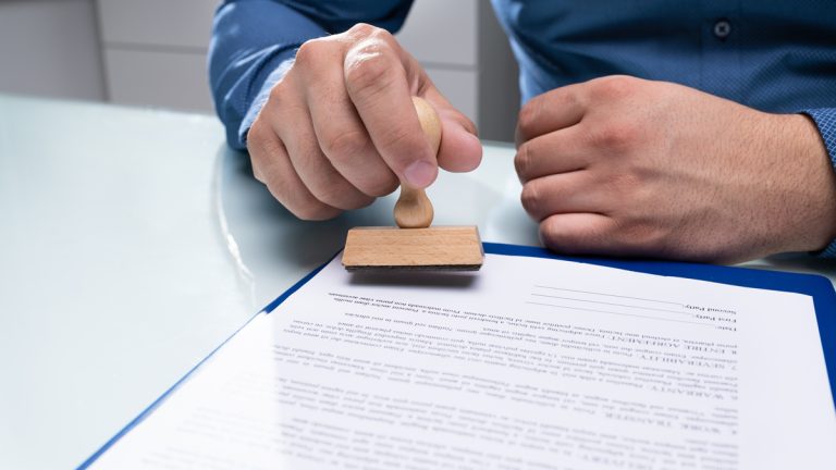 A person stamping an application