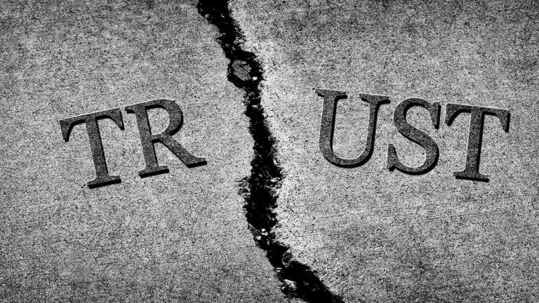 Cracked cement with the word 'trust'