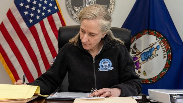 Virginia Governor Abigail Spanberger in the process of signing a bill into law.