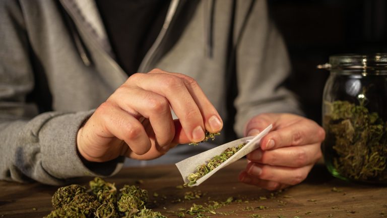 A person rolling a joint