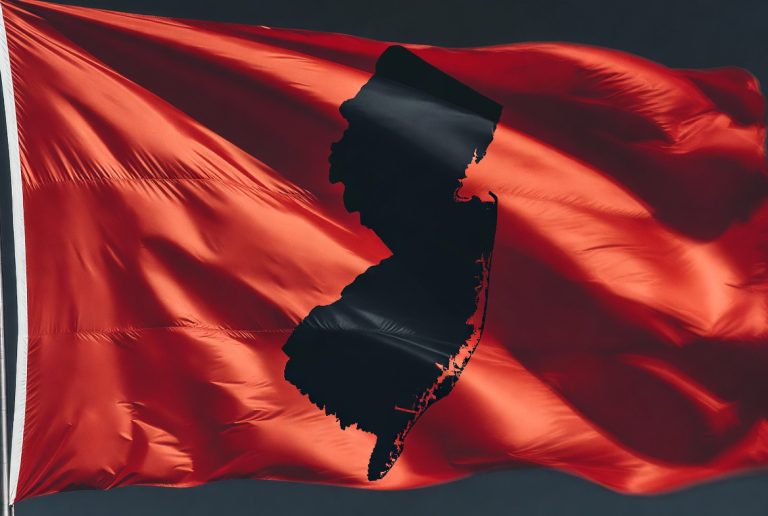A red flag with a New-Jersey-shaped silhouette on it