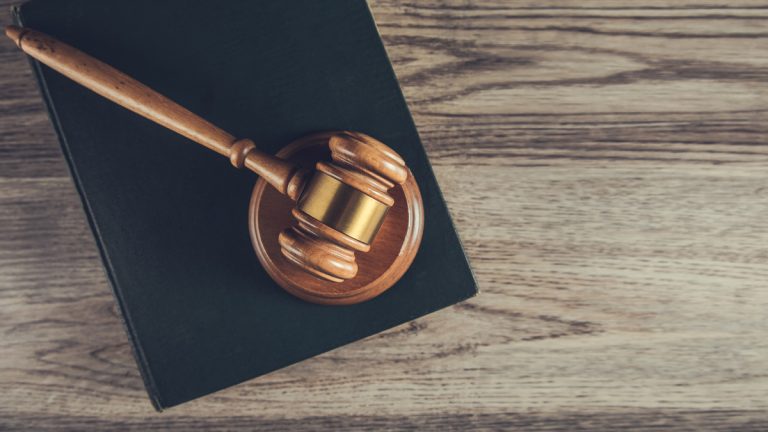 A gavel atop a book