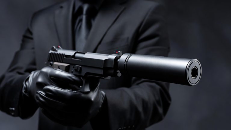 A hitman armed with a pistol with a 'silencer'