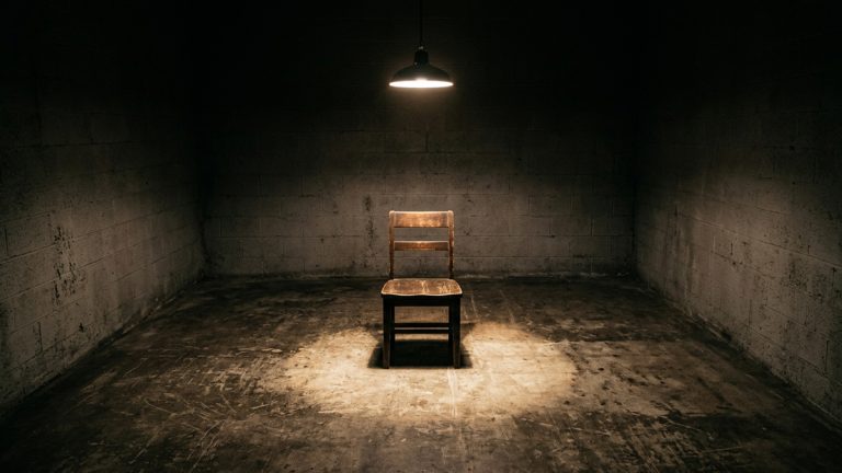 An empty chair under a light